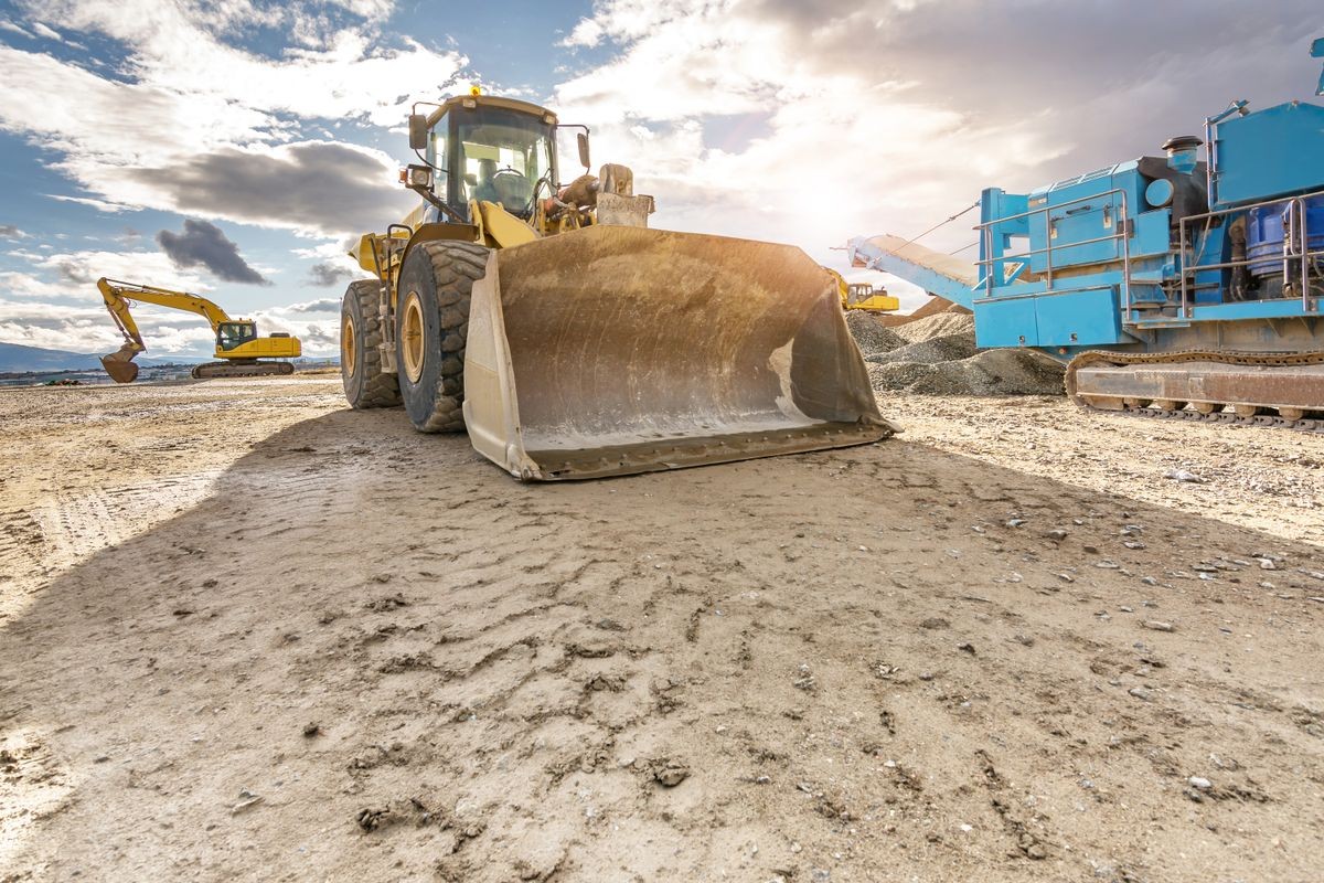 Excavator working on the expansion works of the Segovia bypass road in Castilla y Leon (Spain) Excavator working on the expansion works of the Segovia bypass road in Castilla y Leon (Spain)